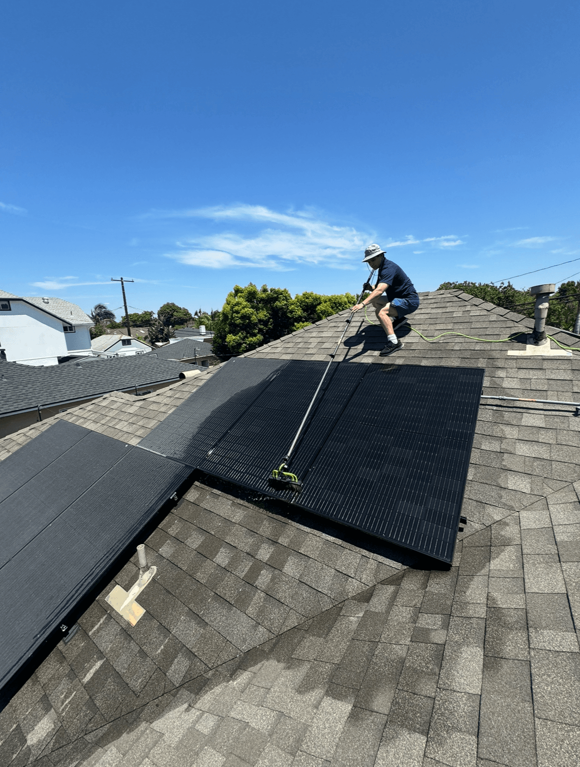 worker cleaning solar panels